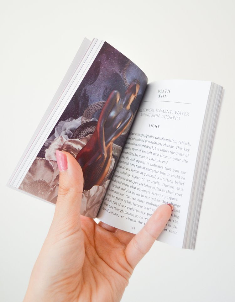 Hands holding tarot deck guidebook during a spiritual tarot reading