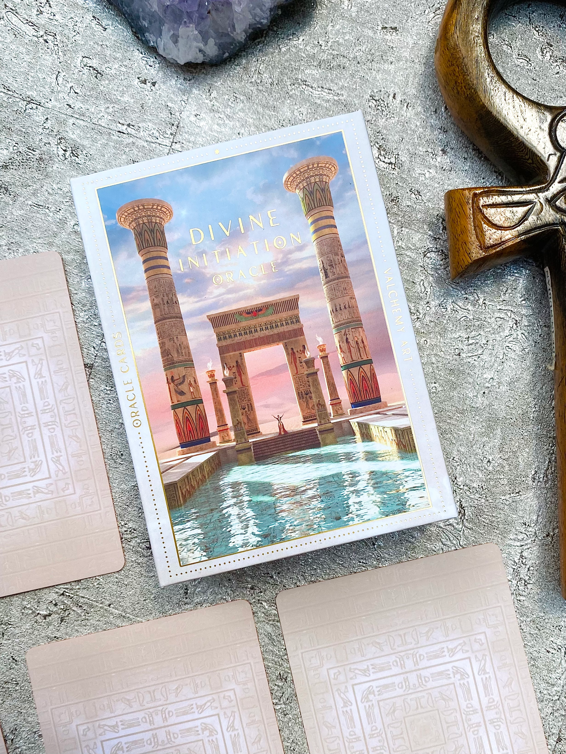 oracle deck Box and cards arranged on altar with Egyptian symbolism and wooden ankh