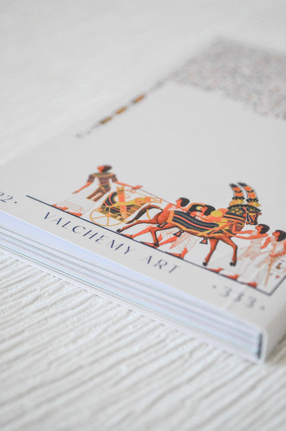 Close up of Egyptian oracle card guidebook artwork and hieroglyphs